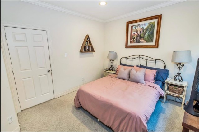 3011 Houston Avenue, Unit B Houston, TX 77009 - Photo 5 of 24 a bedroom with a bed and a painting on the wall