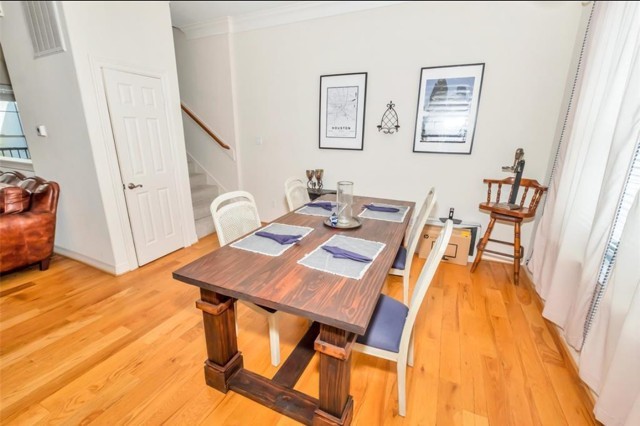 3011 Houston Avenue, Unit B Houston, TX 77009 - Photo 8 of 24 a view of a dining room with furniture and wooden floor