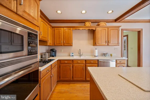 a kitchen with stainless steel appliances granite countertop a sink and cabinets