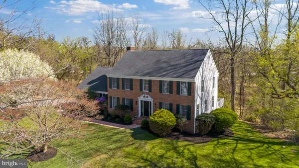 a view of house with yard and sitting area