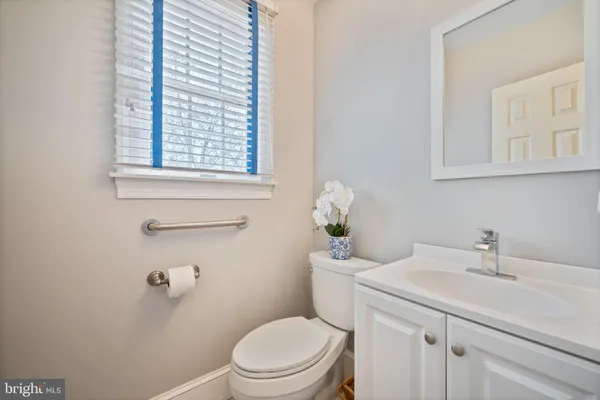 a bathroom with a granite countertop sink a mirror and a shower
