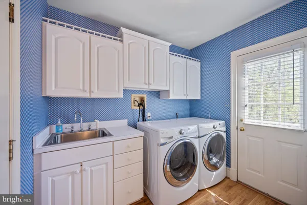 a bathroom with a granite countertop sink and a large mirror