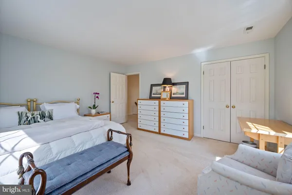 a bedroom with furniture and a lamp