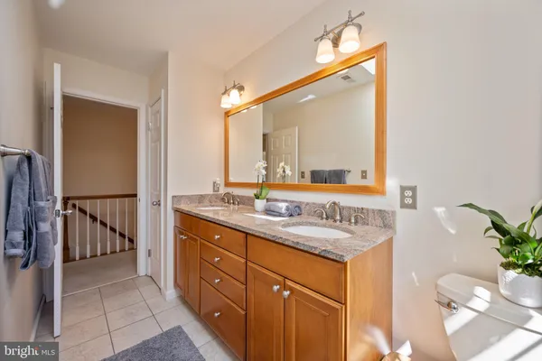 a view of an empty room with white walls and windows