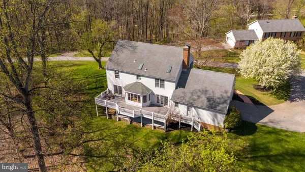 a aerial view of a house with yard and wooden fence