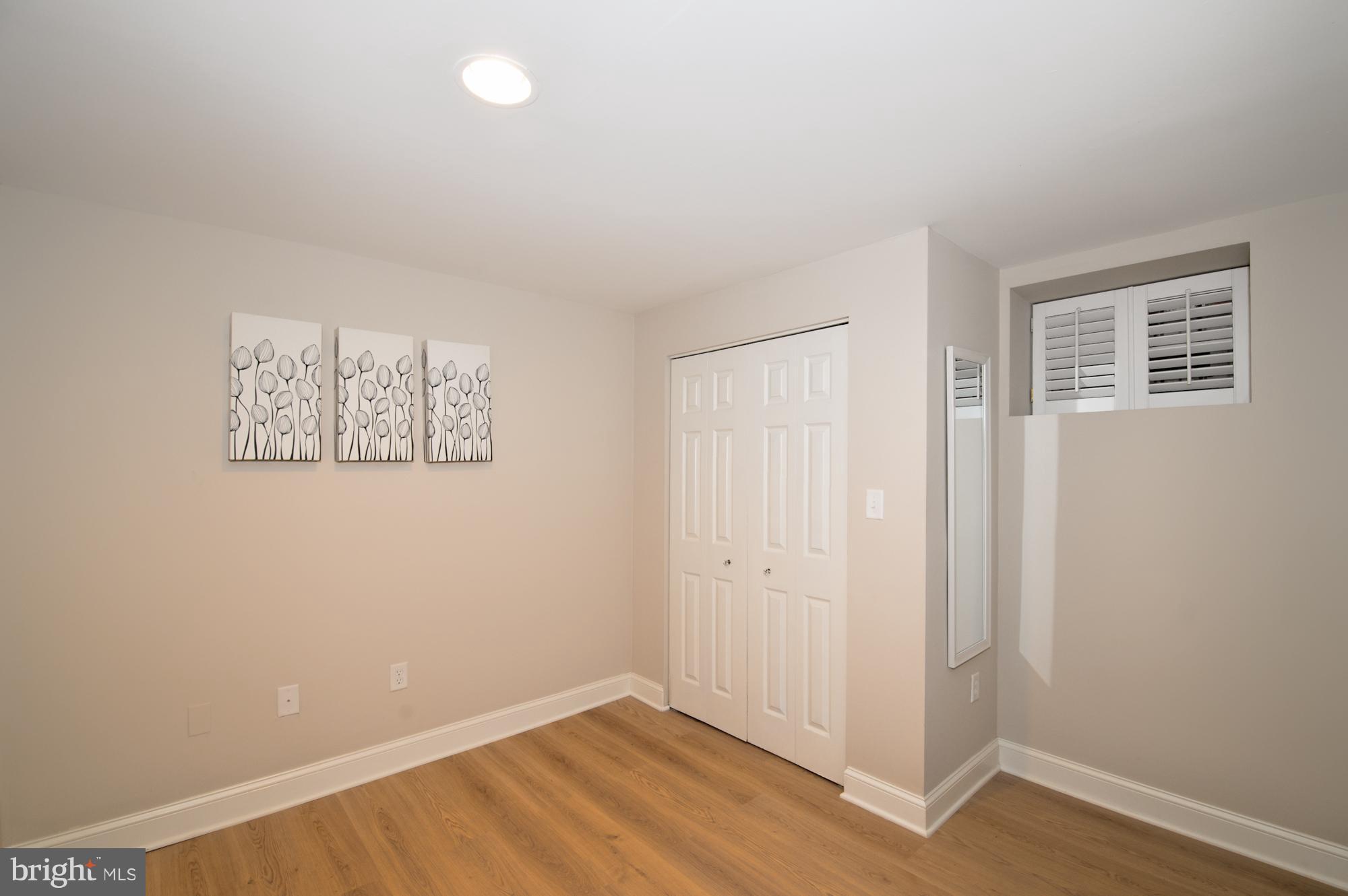 238 10th Street Northeast Washington, DC 20002 - Photo 11 of 30 an empty room with wooden floor and windows