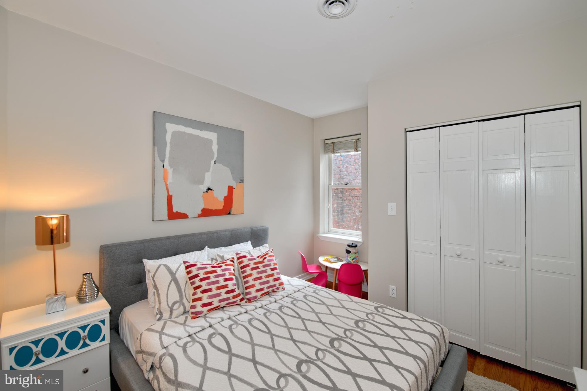 238 10th Street Northeast Washington, DC 20002 - Photo 22 of 30 a bedroom with a bed and wooden floor