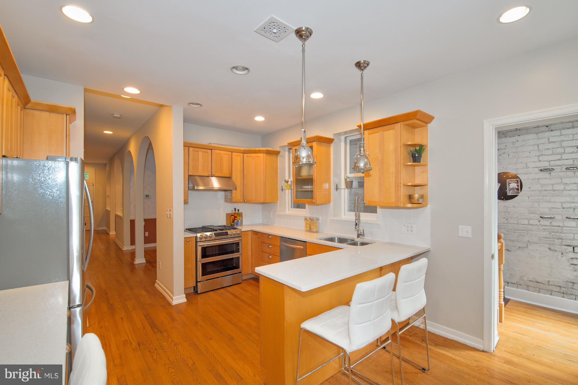238 10th Street Northeast Washington, DC 20002 - Photo 7 of 30 a kitchen with a sink a counter top space stainless steel appliances and wooden floor