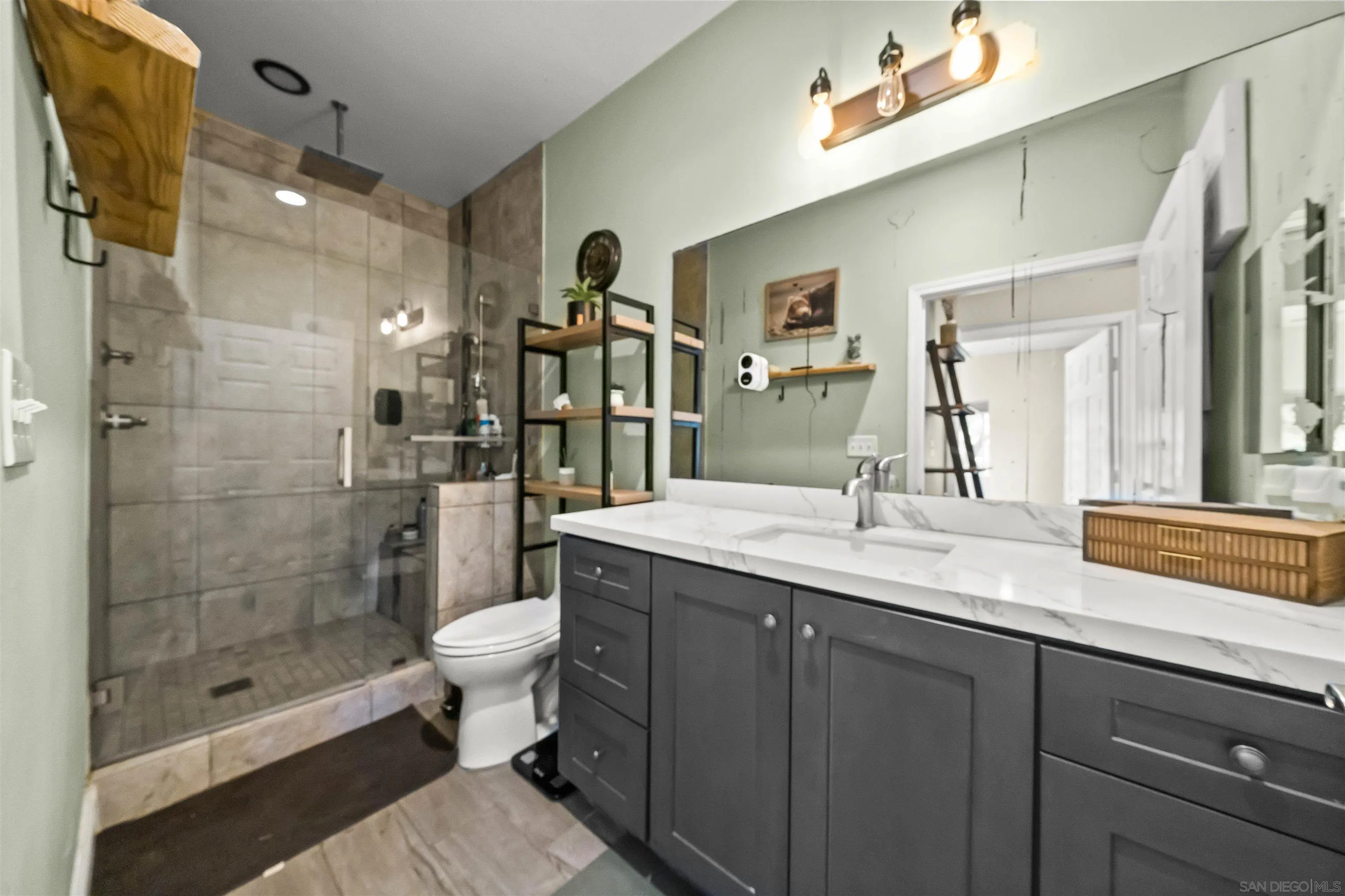 16951 Old Coach Road Poway, CA 92064 - Photo 64 of 70 a bathroom with a granite countertop sink a toilet a mirror and shower