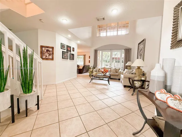 a living room with patio furniture and a large window