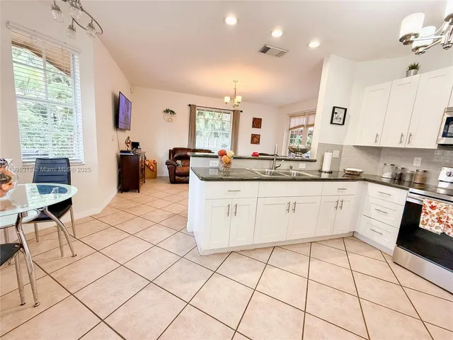 a spacious bedroom with a bed and a chandelier
