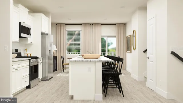 a kitchen with a table chairs refrigerator and cabinets