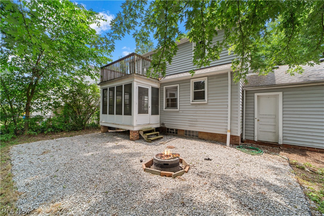 1655 Lyndhurst Road Cleveland, OH 44124 - Photo 29 of 30 Back of property with a sunroom, an outdoor fire pit, and a balcony