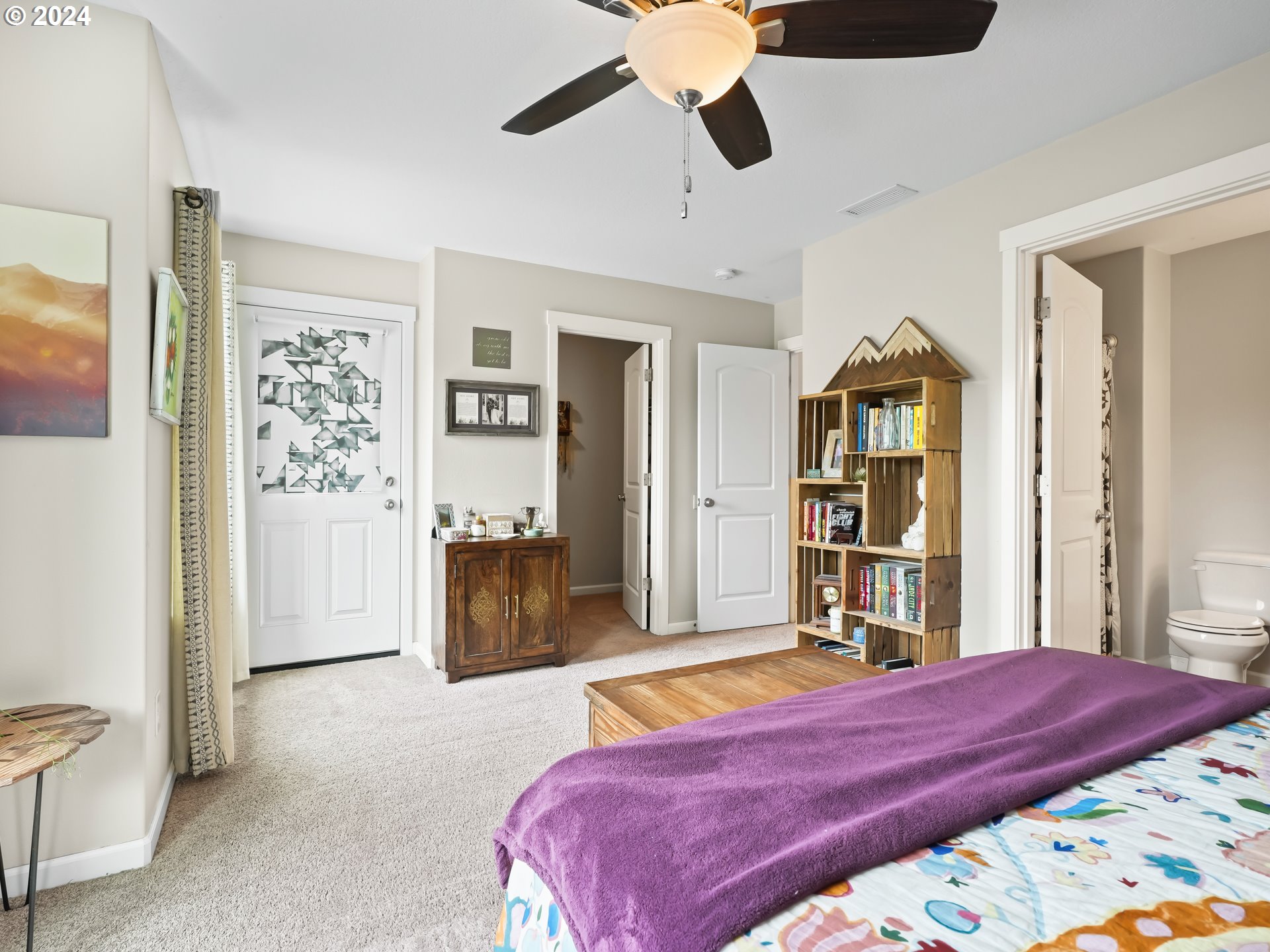 35 North 42nd Place Ridgefield, WA 98642 - Photo 23 of 31 a bedroom with a bed and a walk in closet with wooden floor