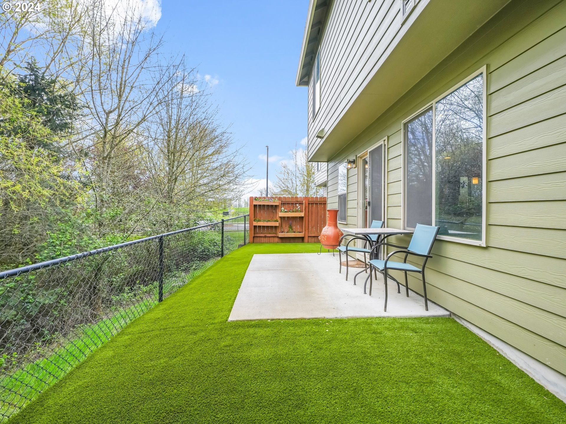 35 North 42nd Place Ridgefield, WA 98642 - Photo 28 of 31 a view of a patio with table and chairs potted plants with wooden floor