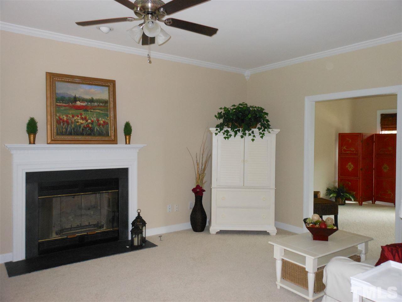 8409 Yucca Trail Raleigh, NC 27615 - Photo 2 of 25 a living room with furniture and a fireplace