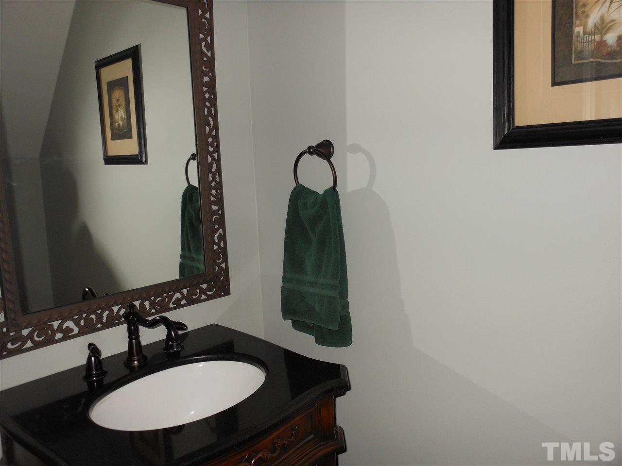 8409 Yucca Trail Raleigh, NC 27615 - Photo 13 of 25 a bathroom with a sink and a mirror