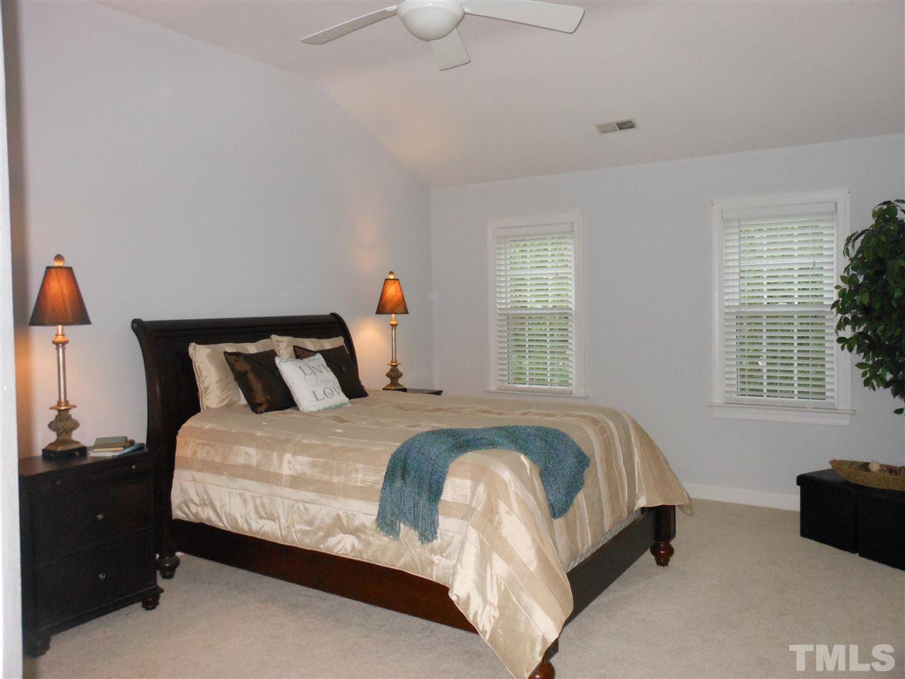 8409 Yucca Trail Raleigh, NC 27615 - Photo 14 of 25 a bed sitting in a bedroom next to a window