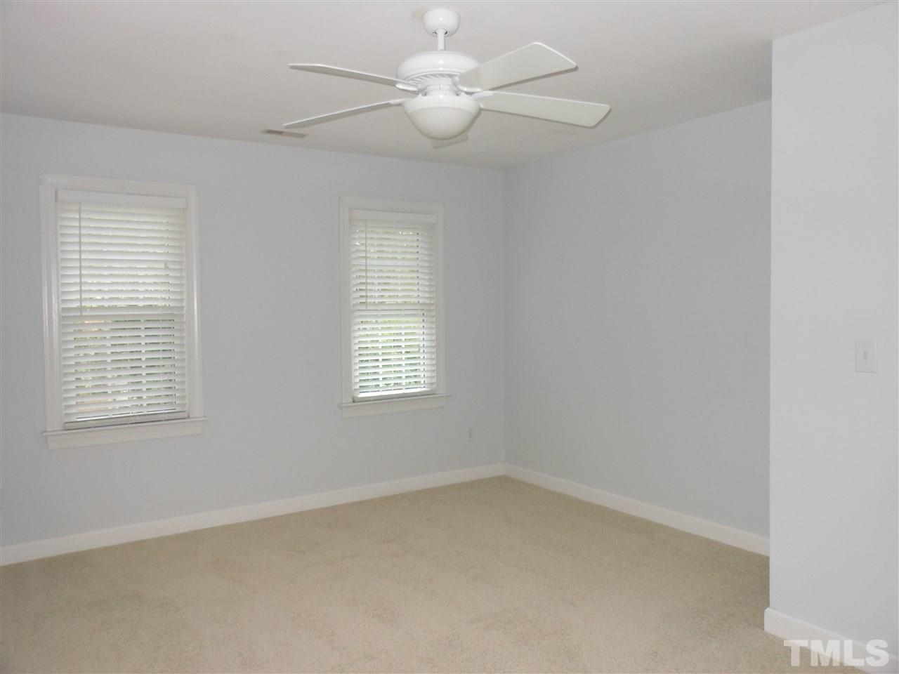 8409 Yucca Trail Raleigh, NC 27615 - Photo 18 of 25 an empty room with a window and a fan
