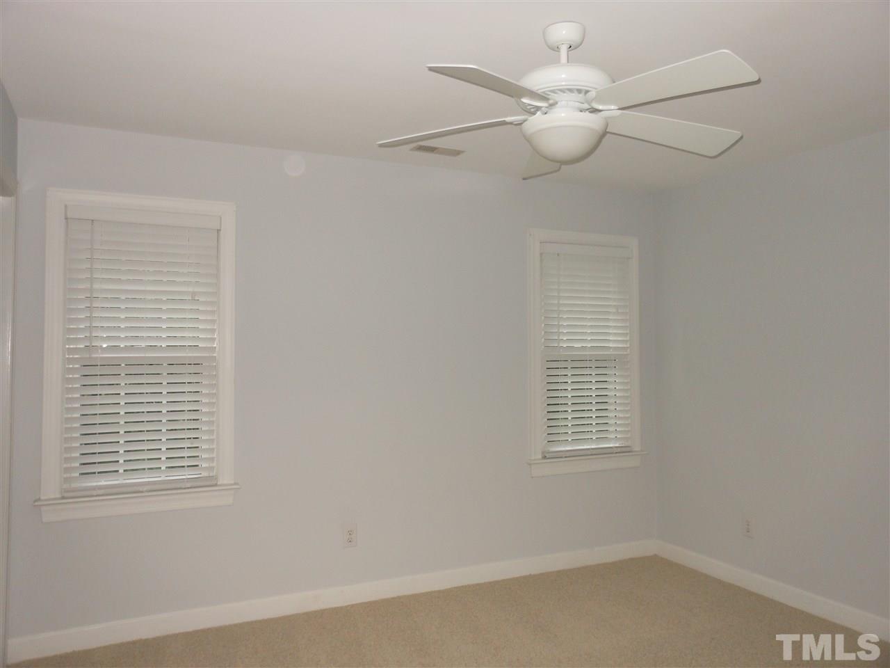 8409 Yucca Trail Raleigh, NC 27615 - Photo 19 of 25 an empty room with windows and fan