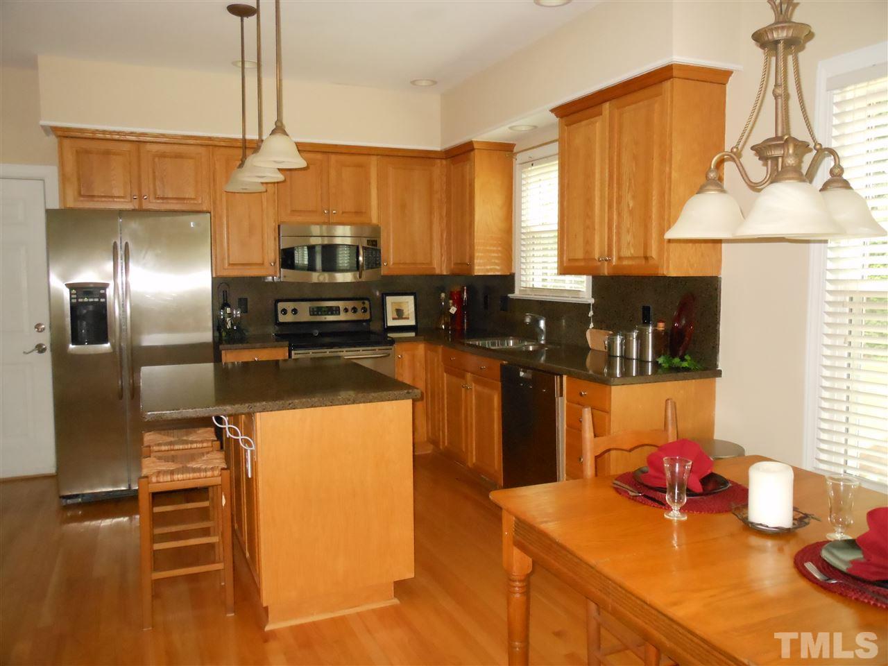 8409 Yucca Trail Raleigh, NC 27615 - Photo 4 of 25 a kitchen with stainless steel appliances a sink a stove and a refrigerator