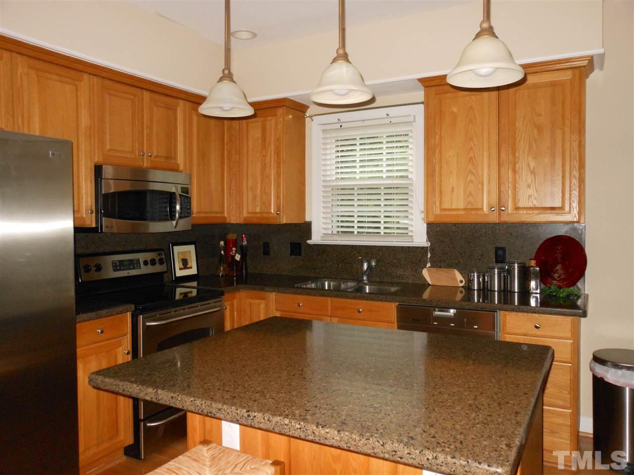 8409 Yucca Trail Raleigh, NC 27615 - Photo 9 of 25 a kitchen with a stove a sink and a microwave