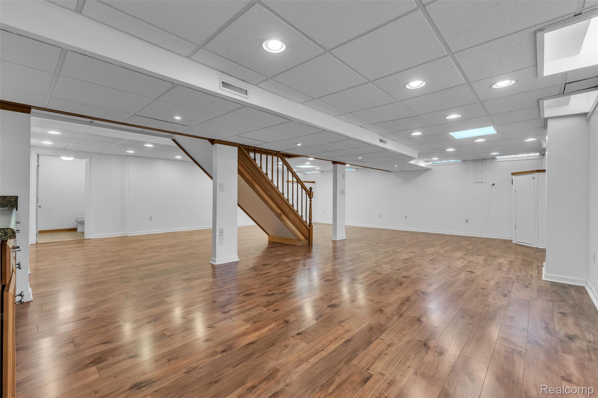 7000 Woonsocket Street Canton, MI 48187 - Photo 52 of 65 Spacious finished lower level featuring wood-finish flooring, recessed lighting, and a neutral color palette