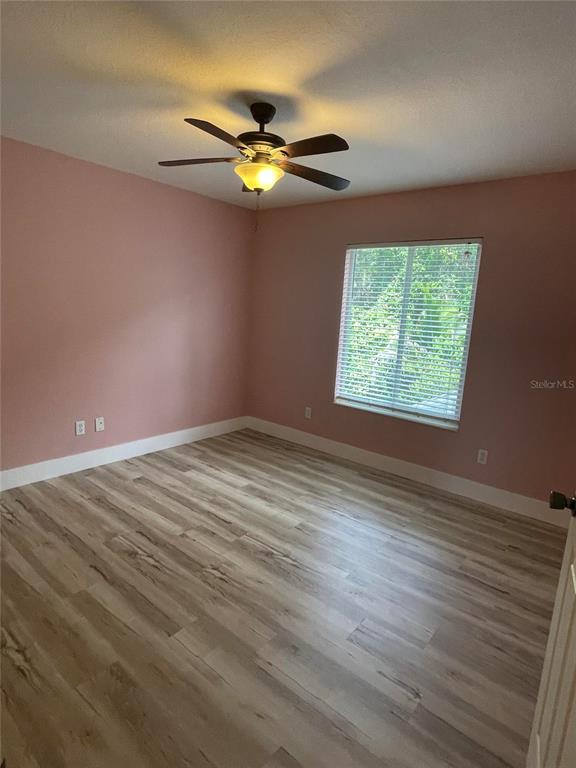 759 Fordingbridge Way Osprey, FL 34229 - Photo 20 of 51 a view of an empty room with wooden floor and a window