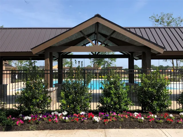 a view of a house with a lot of flower plants