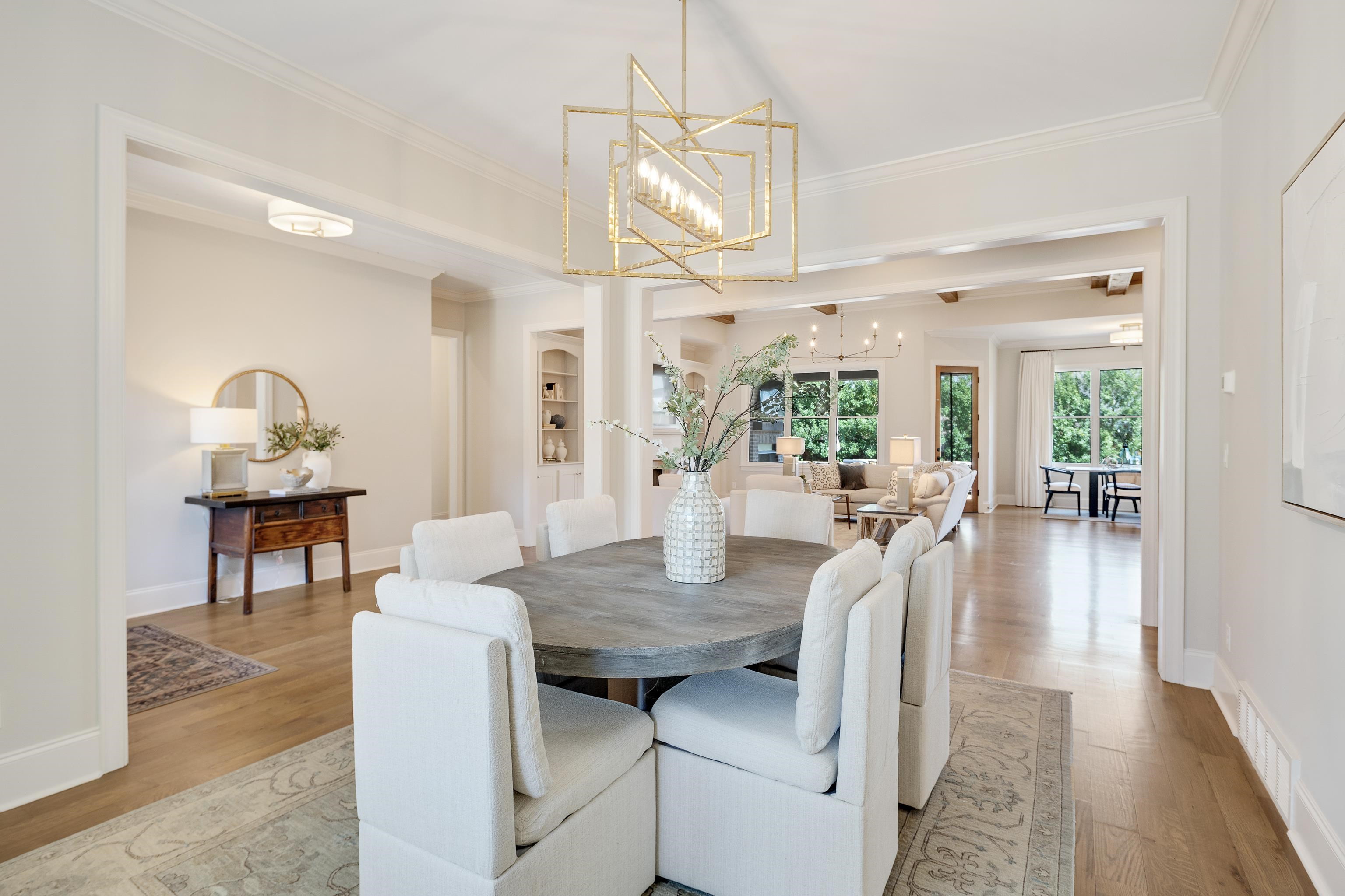 516 Lambs Brook Lane Collierville, TN 38017 - Photo 11 of 39 Dining area featuring hanging lights, light wood finished floors, and crown molding