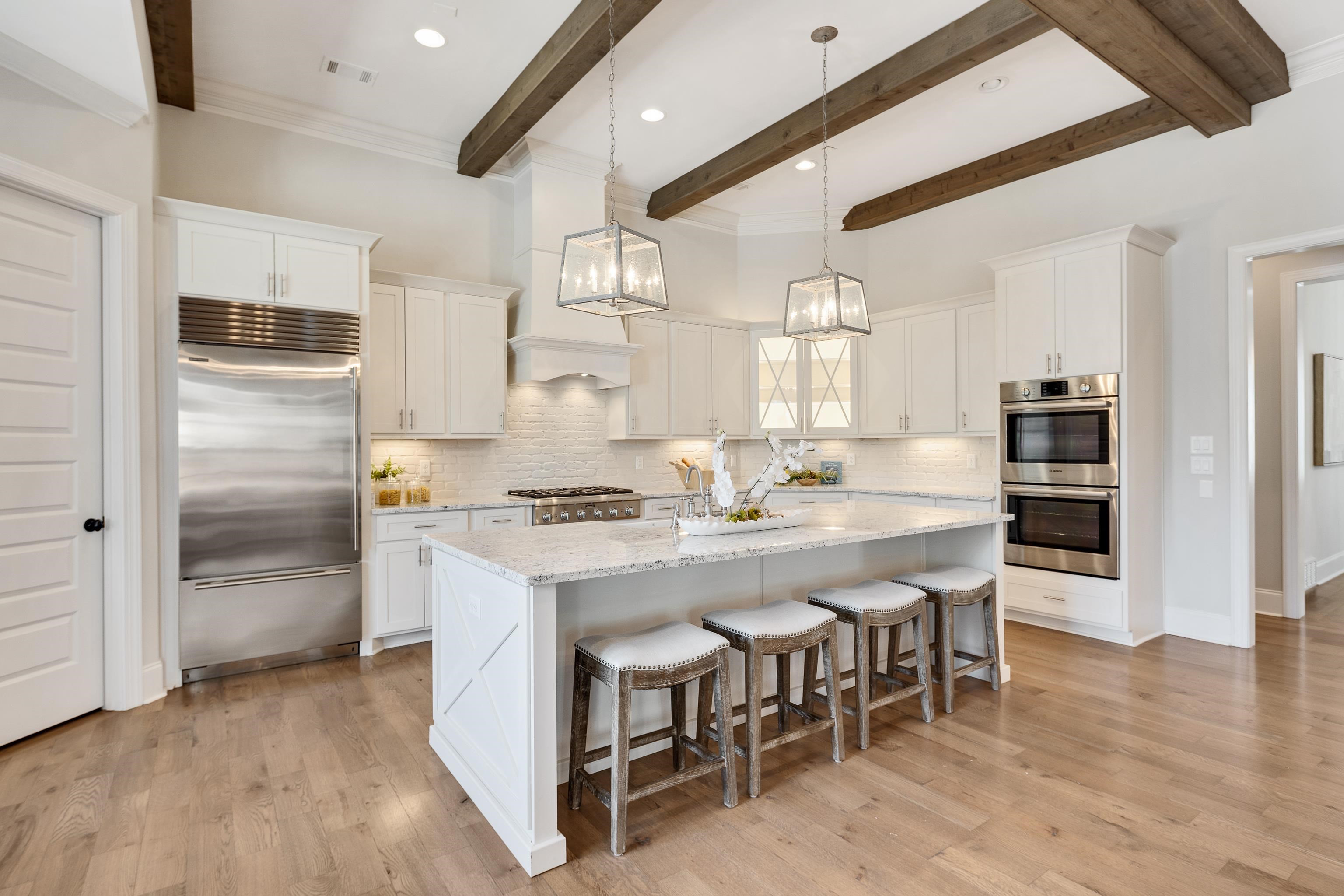 516 Lambs Brook Lane Collierville, TN 38017 - Photo 15 of 39 a kitchen with kitchen island a stove a table and chairs in it
