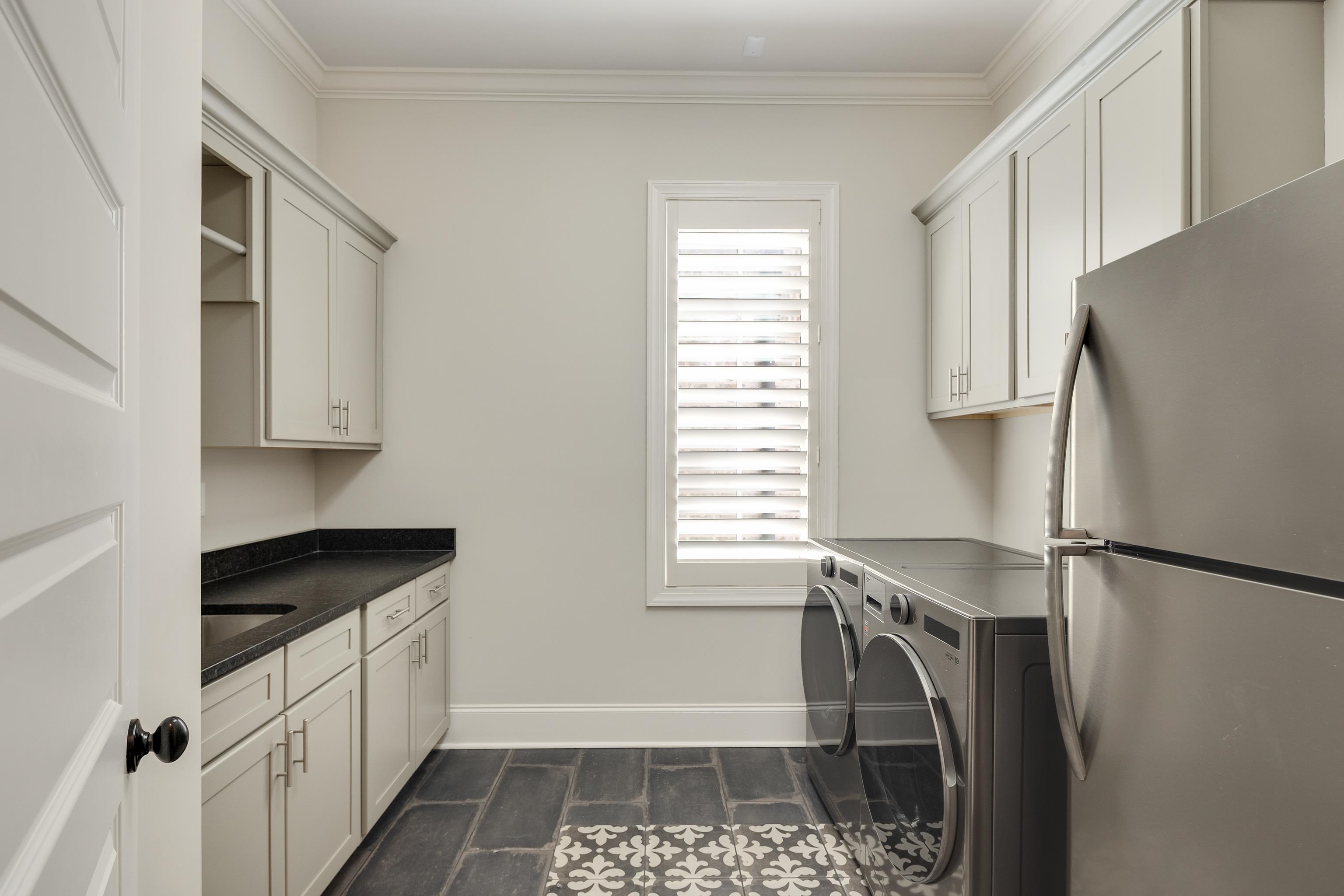 516 Lambs Brook Lane Collierville, TN 38017 - Photo 18 of 39 Laundry room featuring washer and dryer, ornamental molding, and cabinet space