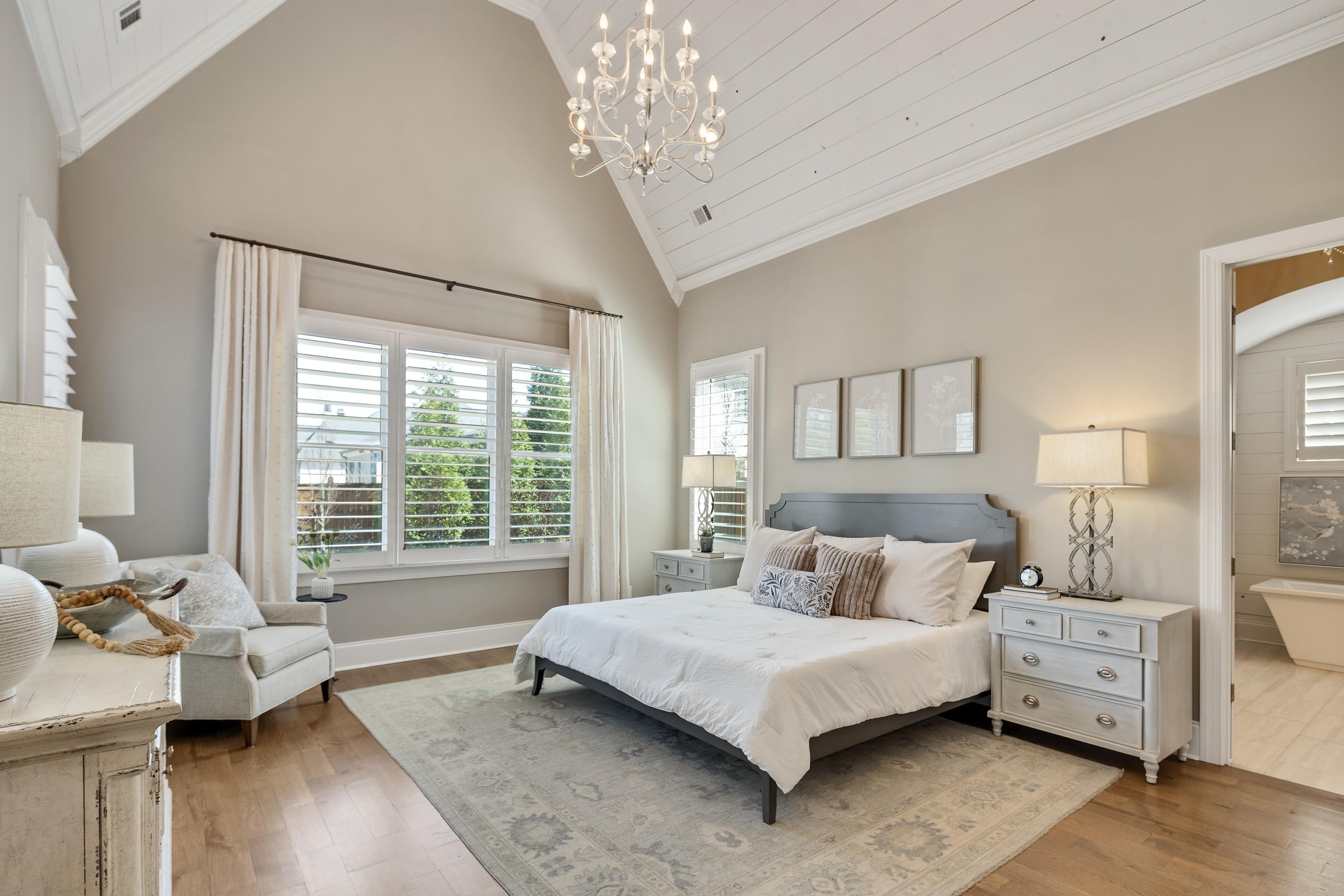 516 Lambs Brook Lane Collierville, TN 38017 - Photo 21 of 39 Bedroom featuring a chandelier, crown molding, wood-type flooring, and vaulted ceiling