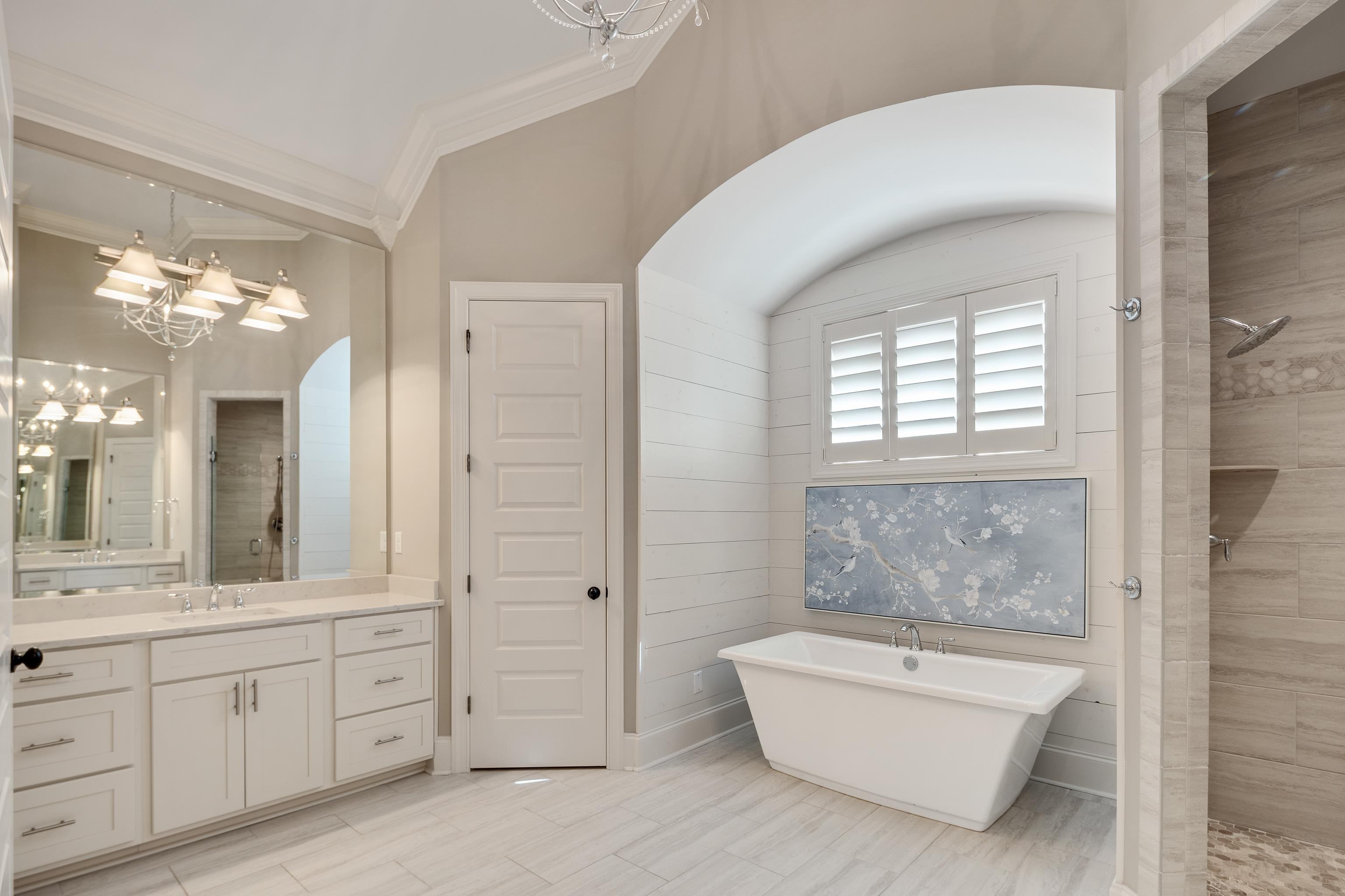 516 Lambs Brook Lane Collierville, TN 38017 - Photo 23 of 39 a spacious bathroom with a double vanity sink a mirror a bathtub and next to a window