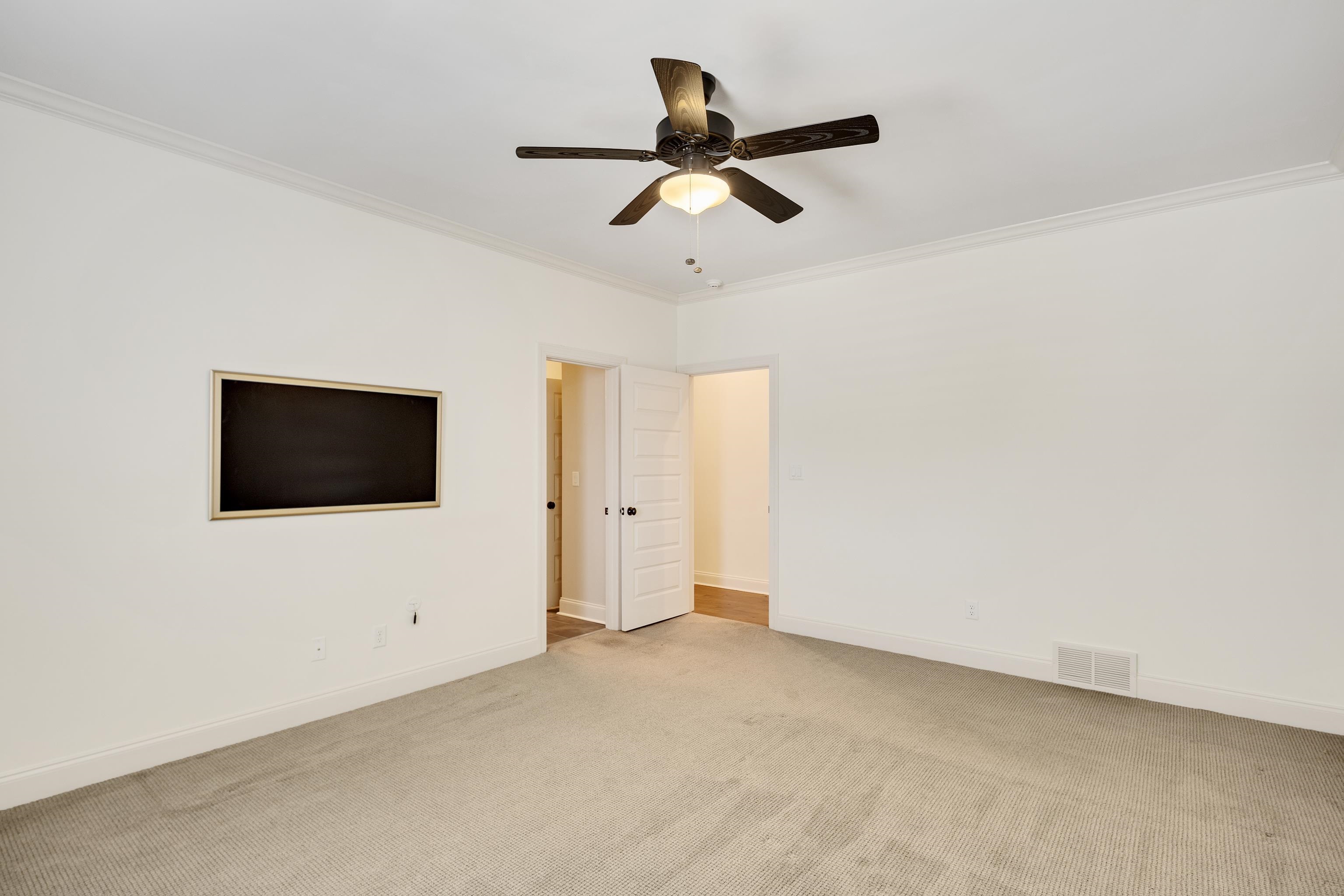 516 Lambs Brook Lane Collierville, TN 38017 - Photo 25 of 39 Unfurnished bedroom featuring crown molding, light carpet, and ceiling fan