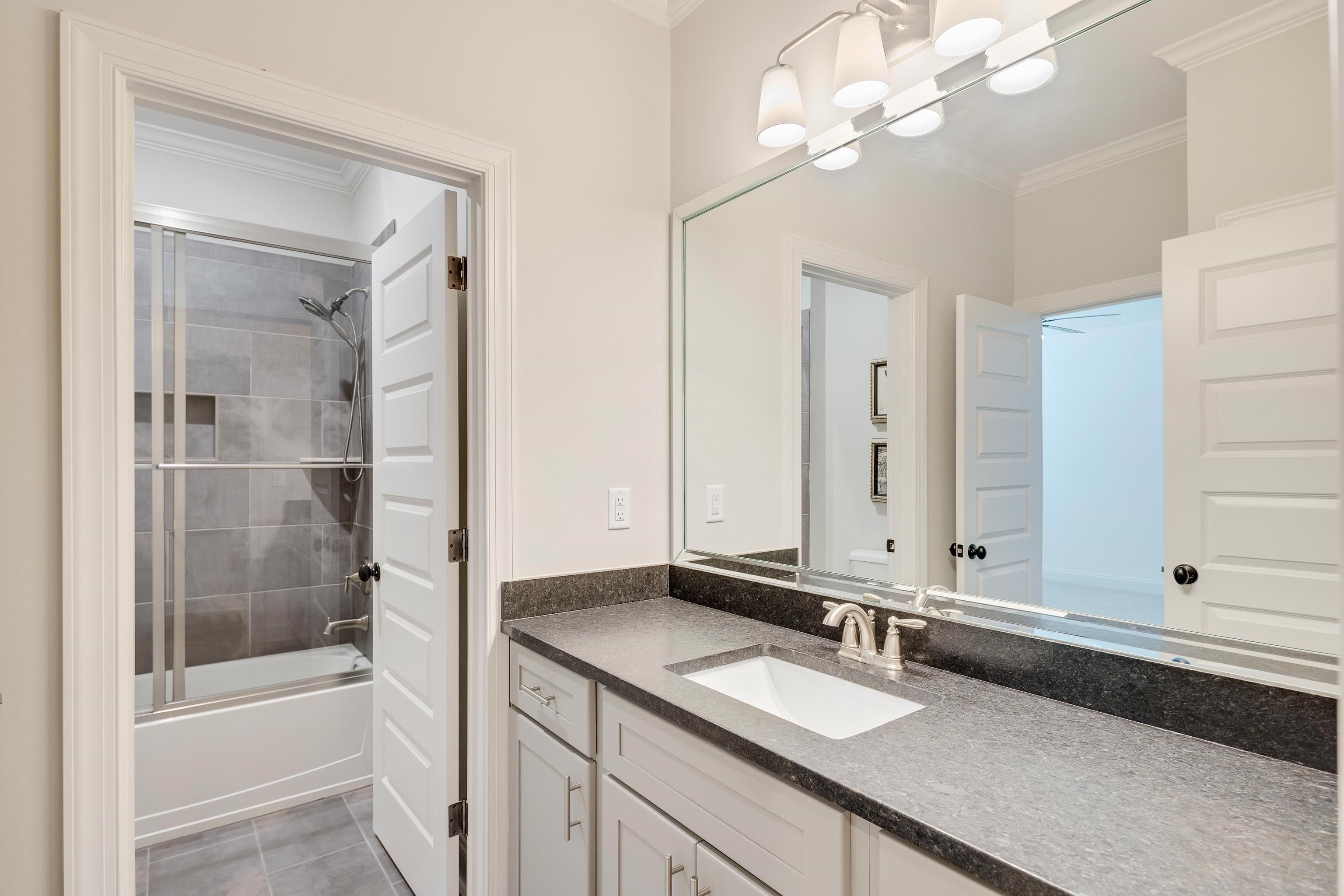516 Lambs Brook Lane Collierville, TN 38017 - Photo 26 of 39 a bathroom with a tub a sink and mirror