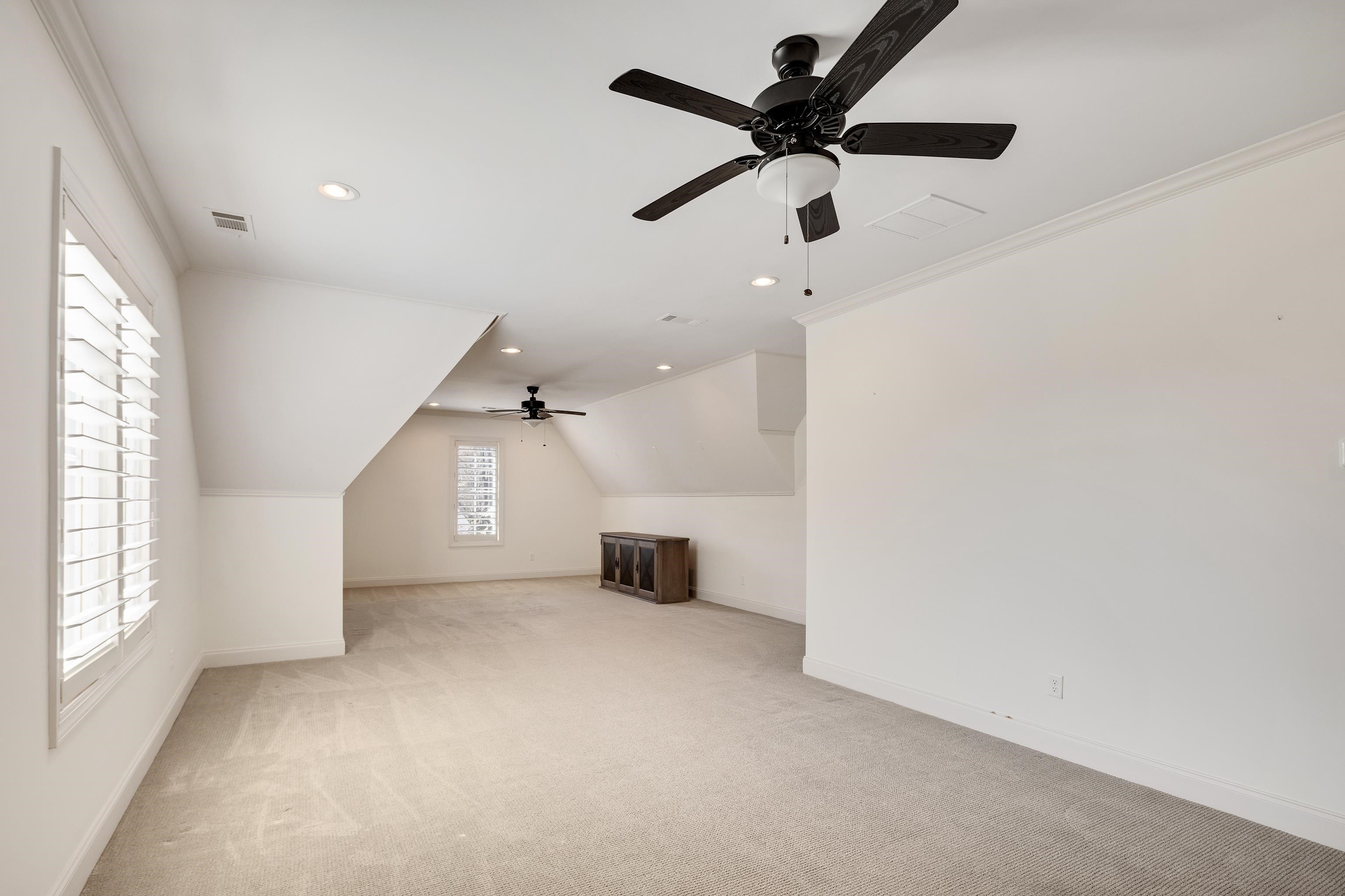 516 Lambs Brook Lane Collierville, TN 38017 - Photo 30 of 39 Additional living space with recessed lighting, a ceiling fan, light carpet, and vaulted ceiling