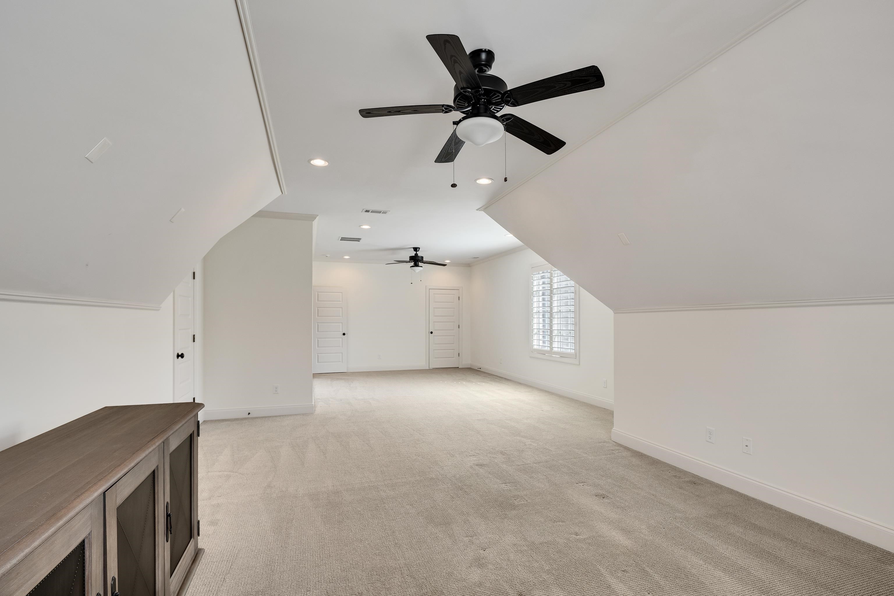 516 Lambs Brook Lane Collierville, TN 38017 - Photo 31 of 39 Additional living space with lofted ceiling, light carpet, a ceiling fan, and recessed lighting