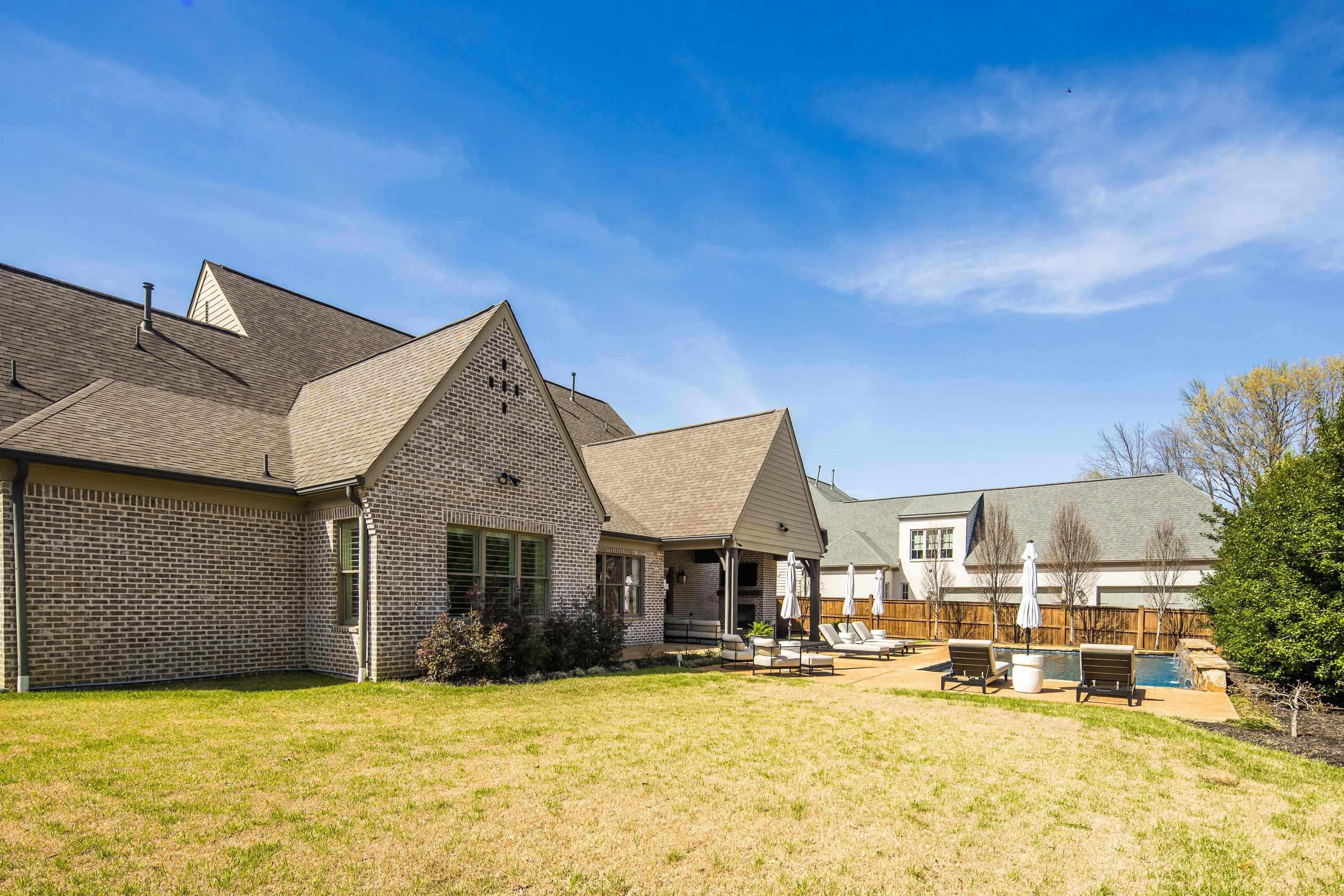 516 Lambs Brook Lane Collierville, TN 38017 - Photo 37 of 39 Rear view of property featuring a patio, brick siding, a fenced backyard, and a shingled roof