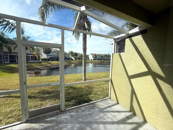 a view of a kitchen with a refrigerator and a window