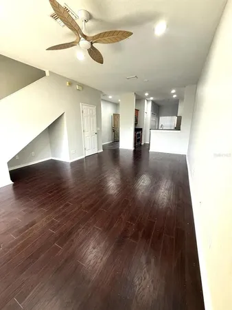 a view of empty room with wooden floor