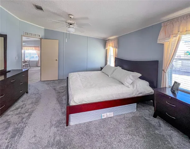 a living room with furniture and a dresser