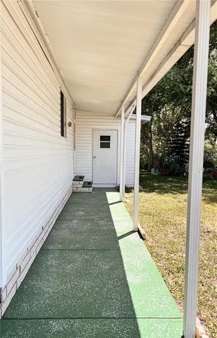 a view of a porch with a floor to ceiling window
