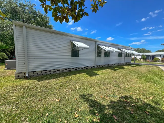 a view of house with backyard