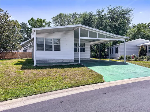 an aerial view of a residential houses with outdoor space