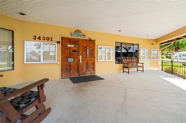 a living room with furniture a window and wooden floor