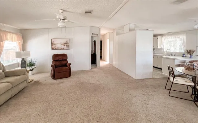 a living room with furniture and a open kitchen