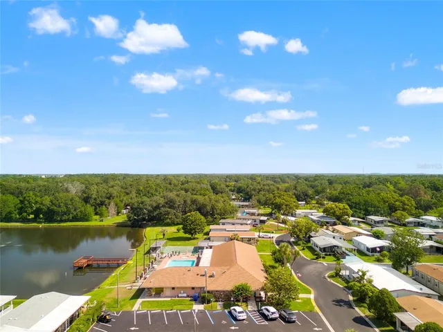 an aerial view of residential houses with outdoor space and parking