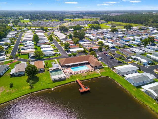 an aerial view of a houses with a swimming pool