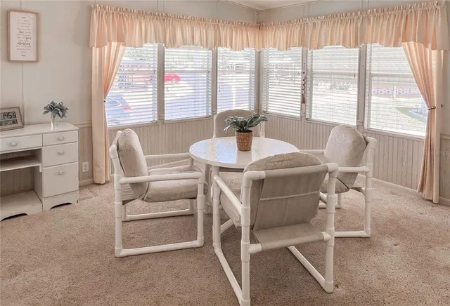 a view of a dining room with furniture and windows